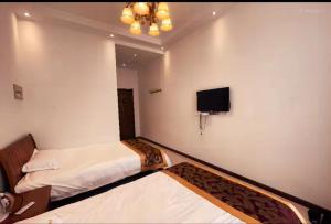 Krevet ili kreveti u jedinici u objektu Yabuli Qingyun County Xin Ding Apartment Hotel