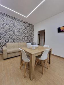 a dining room with a table and chairs and a couch at casale in Brindisi