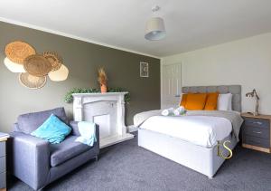 a bedroom with a bed and a chair and a couch at Luke Stays - Hareydene in Lemington