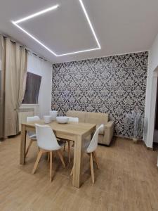 a dining room with a wooden table and white chairs at casale in Brindisi +10 photos