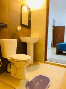 a bathroom with a toilet and a sink at White Villa in Weligama