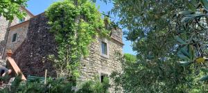 an old stone building with ivy growing on it at Casa Nicola, large country house with pool in Pistoia