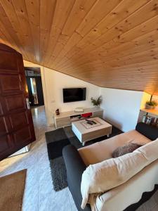 a living room with a couch and a flat screen tv at Apartament Villa Luisa in Can Trabal