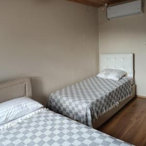 two beds sitting next to each other in a room at Villa Pamuklu second floor only in Çaykara