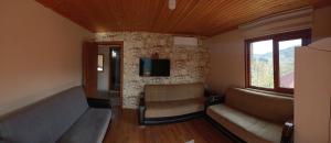 a living room with two couches and a tv at Villa Pamuklu second floor only in Çaykara