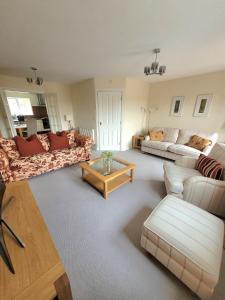 a living room with two couches and a coffee table at Golden Valley View in Codnor