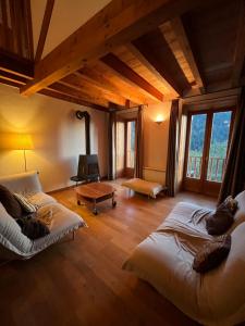 a large room with two beds and a fireplace at Apartment Belledonne 3 minutes from Alpe d Huez Grand Domaine via Oz en Oisans in Oz