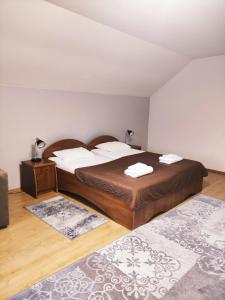 a bedroom with two beds and two rugs at Hotel Delfin in Mukacheve