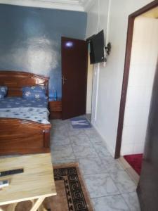 um quarto com uma cama e uma porta para uma casa de banho em Buzsahm em Dakar