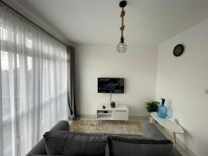 a living room with a couch and a tv at One Bedrooms & Studios at Ngong Rd in Nairobi