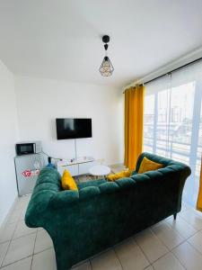 a living room with a green couch and a table at One Bedrooms & Studios at Ngong Rd in Nairobi +29 photos