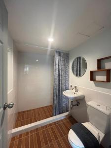 a bathroom with a toilet and a sink at Nautical Home B&B Khaolak in Khao Lak