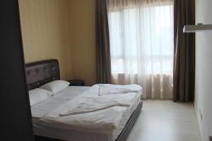 Ένα ή περισσότερα κρεβάτια σε δωμάτιο στο Sausana Suites D' Bliss