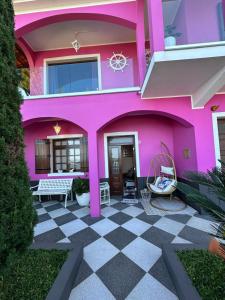 a pink house with a checkered floor at Residência Mendonça in Faial