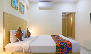 a bedroom with a large bed in a room at FabHotel Swarnas in Vijayawāda
