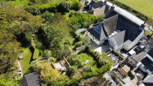 an overhead view of a house with a yard at Spacious Thatched Cottage in West Lulworth, Dorset in West Lulworth