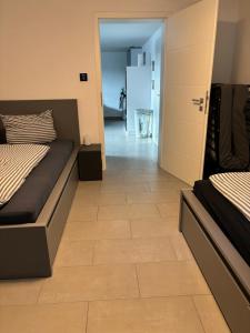 a bedroom with two beds and a tile floor at Ferienwohnung Annashome in Maxhütte-Haidhof