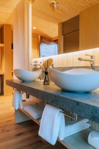 a bathroom with two sinks on a counter with towels at Andeluna Winery Lodge in Tupungato