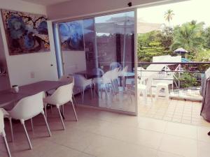 a dining room with a table and chairs and a patio at Apartasol Santafe de Antioquia in Santa Fe de Antioquia
