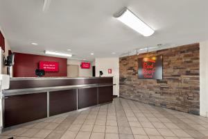 a bar in a restaurant with a brick wall at Red Roof Inn Winchester, VA in Winchester