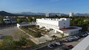 an aerial view of a building with a parking lot at Mountain View Apartment in Port Alcudia in Port d'Alcudia