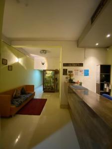 a living room with a couch and a kitchen at Alhanney Housing in Guwahati