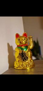 a gold cat statue sitting on top of a table at Ap Central Traian Moșoiu 2 Parcare proprie in Cluj-Napoca