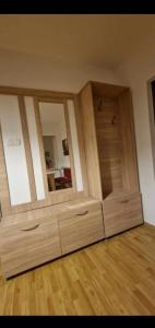 a room with a large wooden cabinet with mirrors at Ap Central Traian Moșoiu 2 Parcare proprie in Cluj-Napoca