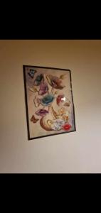 a picture hanging on a wall with birds on it at Ap Central Traian Moșoiu 2 Parcare proprie in Cluj-Napoca