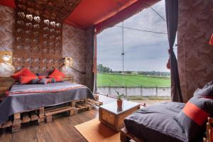 a bedroom with two beds and a large window at Shalom Corbett’s Hillside Hideaway in Belparāo