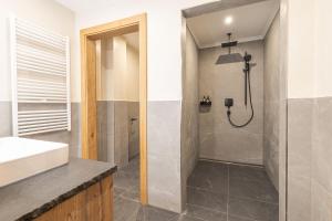 a bathroom with a shower and a sink at Grubi´s Chalet Alm in Gerlos +19 photos