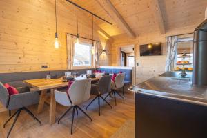 a dining room with a table and chairs at Grubi´s Chalet Alm in Gerlos