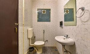 a bathroom with a toilet and a sink at FabHotel Gangashrey in Jaipur
