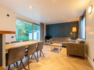 een woonkamer met een tafel en stoelen en een bank bij Holiday home in South Holland with shared pool in Zevenhuizen