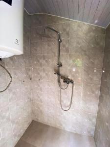 a shower with a shower head in a bathroom at MTIRALA HOTEL ZIPO in Ch'ak'vist'avi
