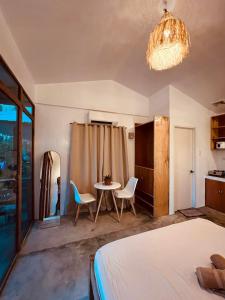 a bedroom with a bed and a table and chairs at Dee Siargaonon Homestay in General Luna