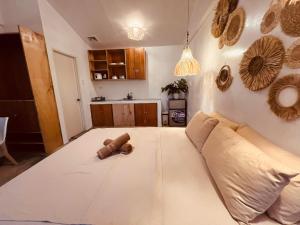 a living room with a couch and a teddy bear on the floor at Dee Siargaonon Homestay in General Luna +19 photos