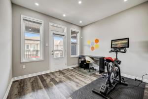 a home gym with a treadmill and a desk at Modern Family Friendly 4BR Home Away From Home in Milton