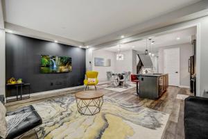 a living room with a yellow chair and a desk at Modern Family Friendly 4BR Home Away From Home in Milton