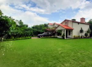 a house with a large lawn in front of it at Voyager's Nest in Phanda