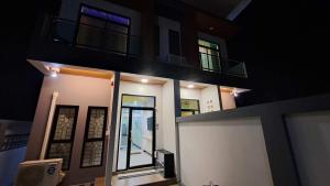 a building with a door and a balcony at night at Hatyai.Muslim.Home in Hat Yai