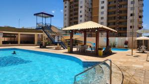 a swimming pool with a person in the water at Prive das Thermas - 301B in Caldas Novas