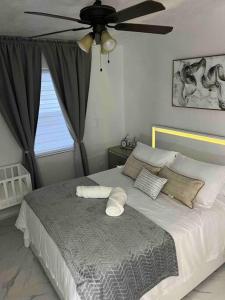 a bedroom with a bed with a ceiling fan at Charming 2-Room Oasis - Miami in Tamiami