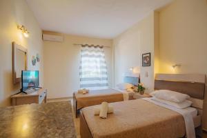 En eller flere senge i et værelse på Villa Rosa Apartments