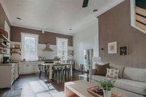 a living room and kitchen with a couch and a table at 1900's Historic Lancaster School House in Willow Street