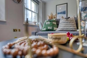 a living room with a couch and a table at 2 Bed Stylish Spacious Apt -Sleeps 6 Central Cheltenham, with Free Parking - By Blue Puffin Stays in Cheltenham