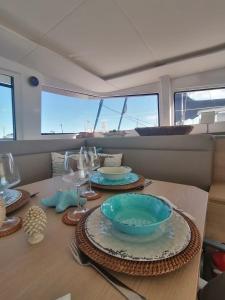 a table with plates and bowls on top of a boat at Magnolia House Boat in Palermo