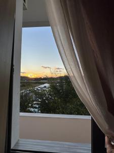 a window with a view of a sunset at Hostel Rinas in Rinas