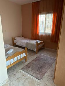 a small room with two beds and a window at Hostel Rinas in Rinas