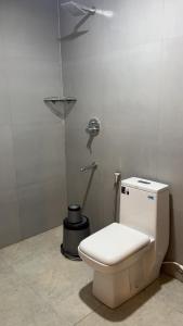 a bathroom with a toilet with a light on the wall at Hotel Dream Suite, Kattappana in Kattappana